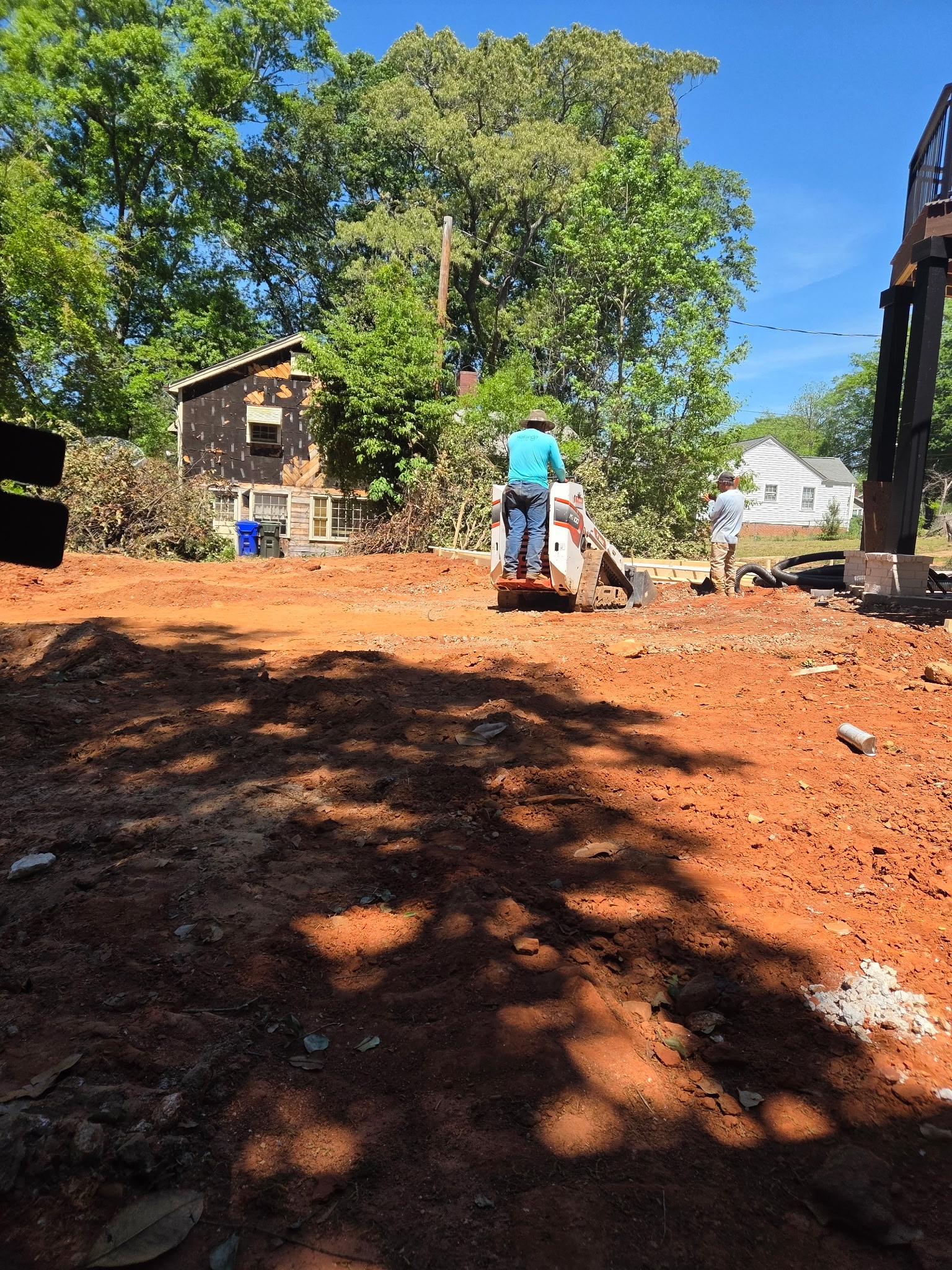 Excavation and grading work with compact equipment on a residential site